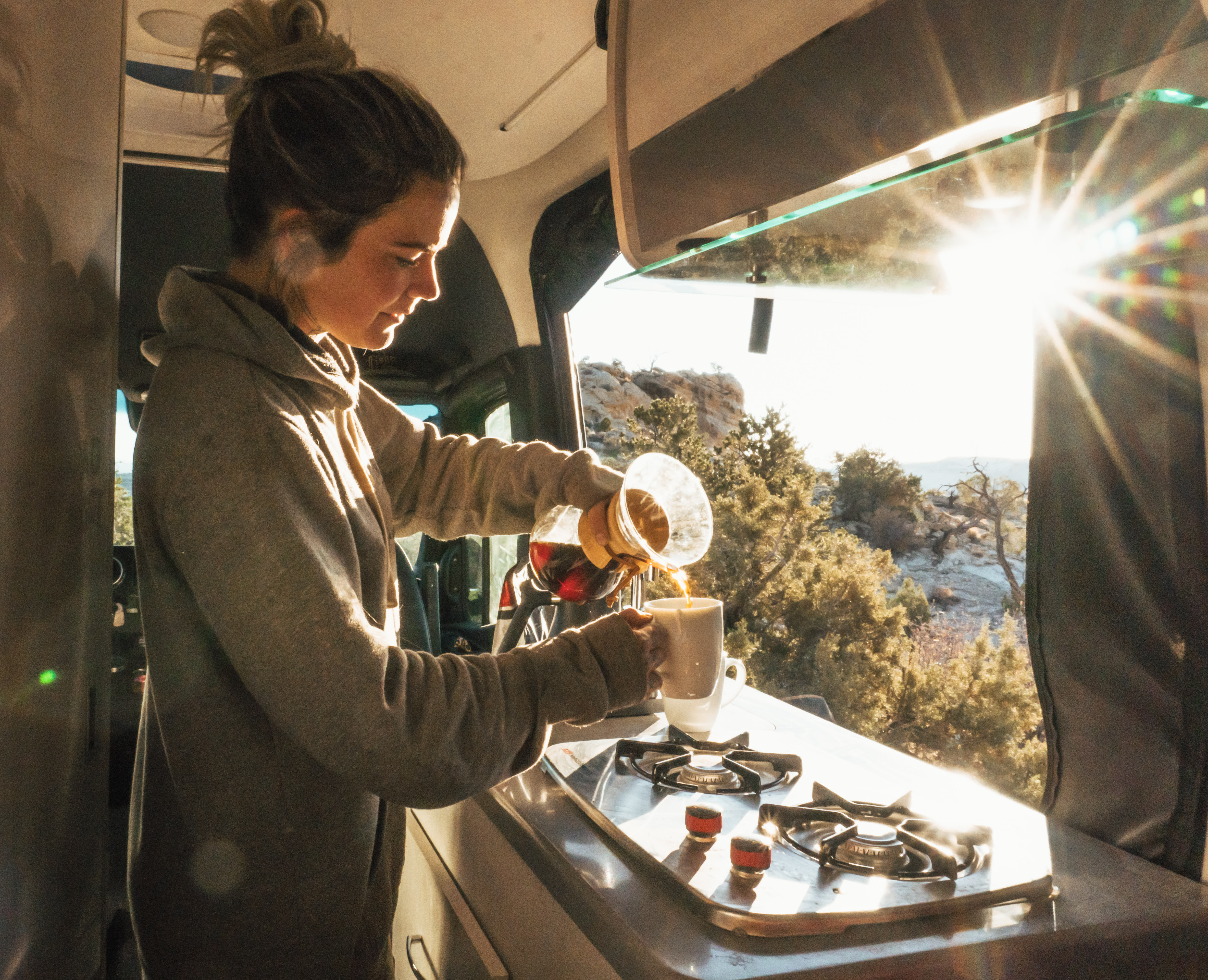2022 Thor Sanctuary Sprinter Van Sprinter RV Lifestyle Kalen Thorien Corporate photo shoot in utah making breakfast pouring coffee