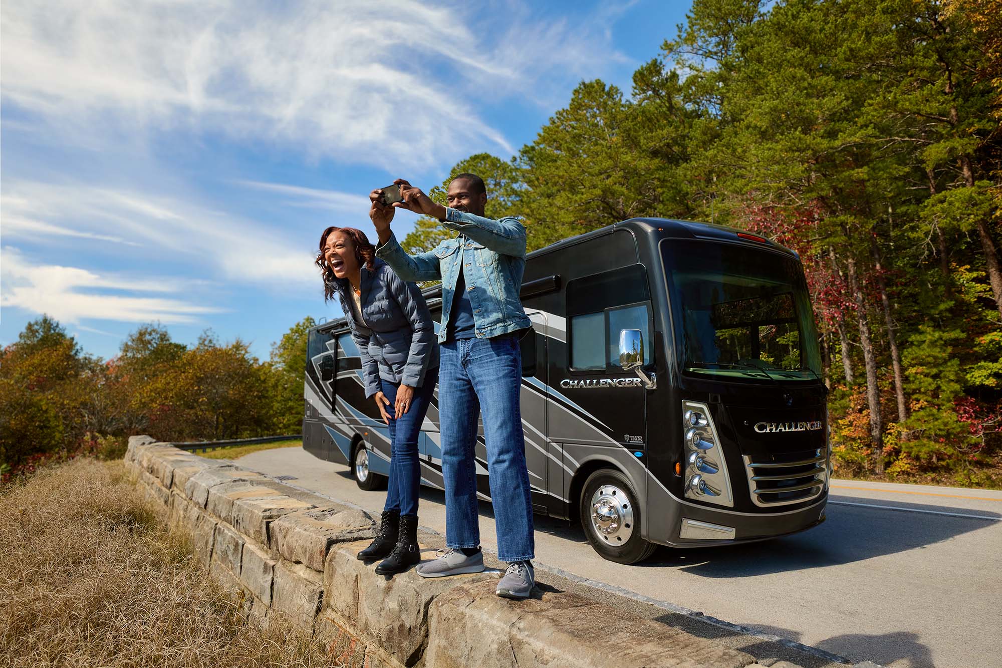 2022 Thor Challenger Class A RV Lifestyle Tennessee Couple laughing and taking selfie fall leaves