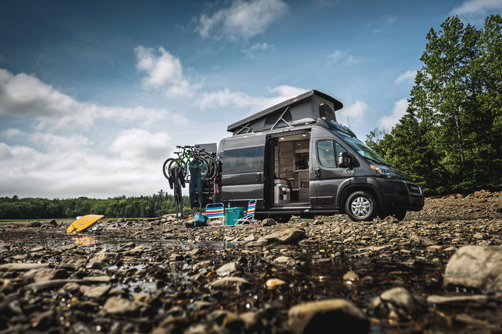 2022 Thor Scope Class B RV Camper Van Lifestyle Maine Corporate photo shoot parked at campsite side view SkyBunk® Sky Bunk Pop top extended