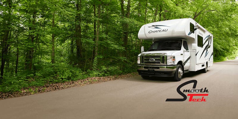 Chateau driving in woods with smoothtech logo