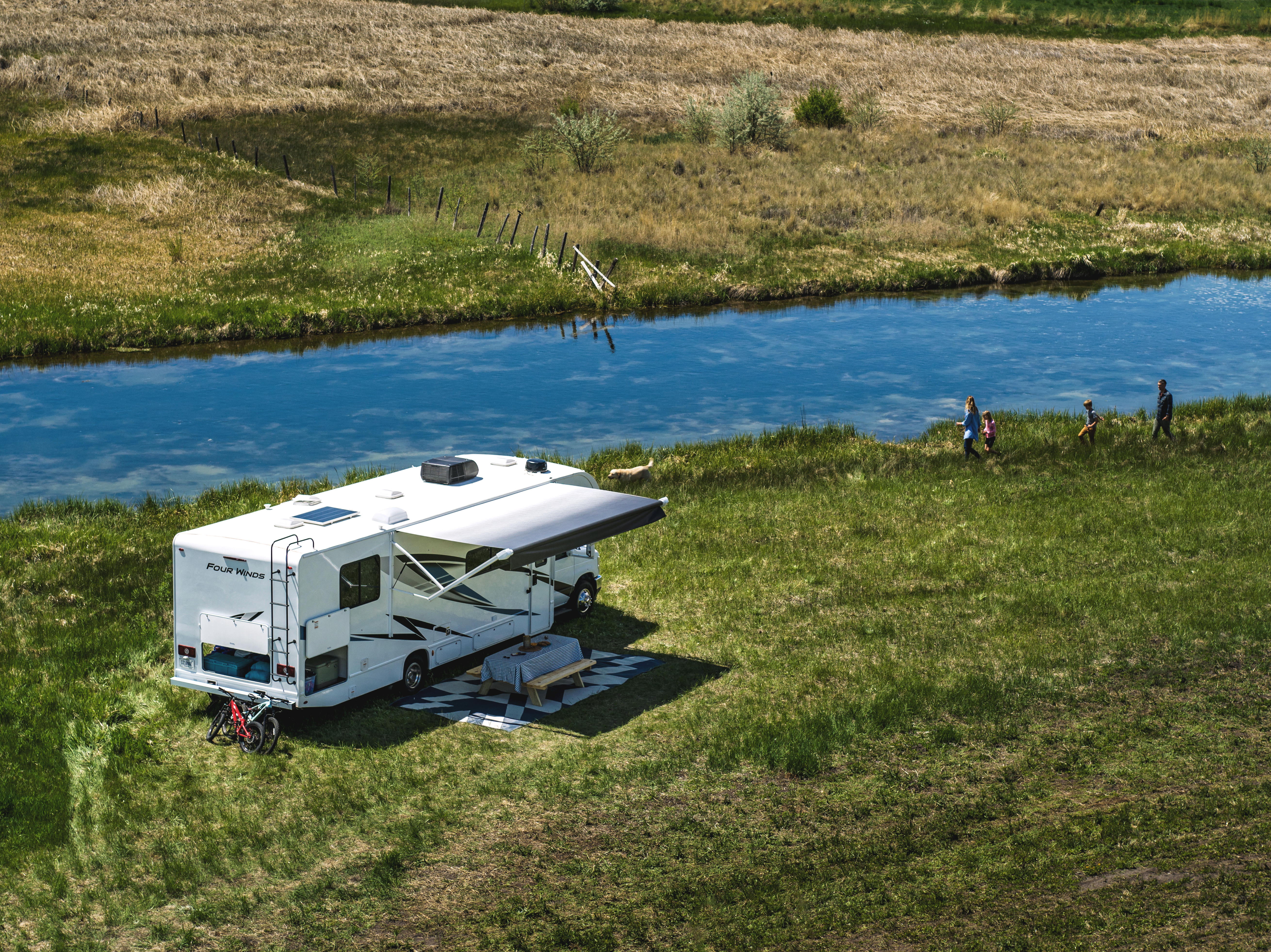 Aerial view of Four Winds class C motorhome beside river