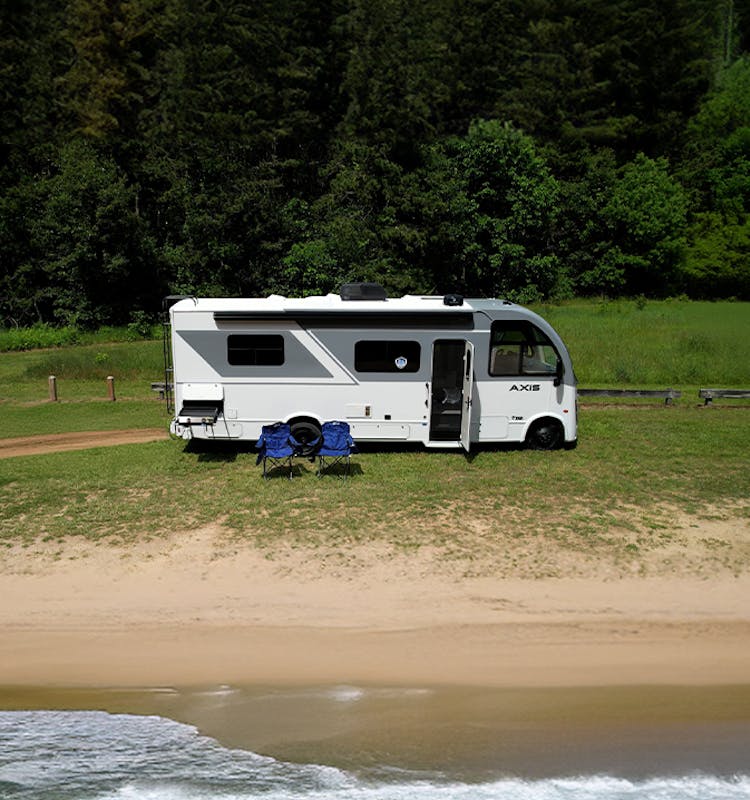 Axis 26.1 parked beside the coast with a pond behind