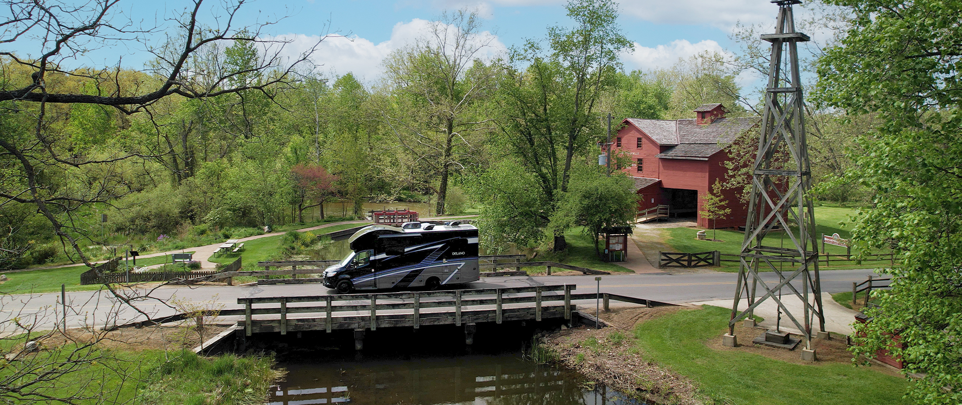 Delano driving past farm over a bridge