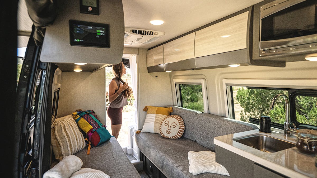 Tranquility Mercedes-Benz Sprinter interior with woman using the motorhome