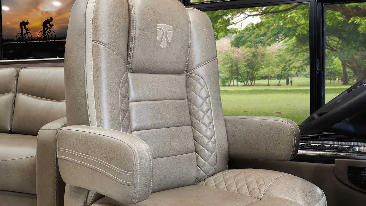 Aria captain's chair with lumbar support and greenery behind