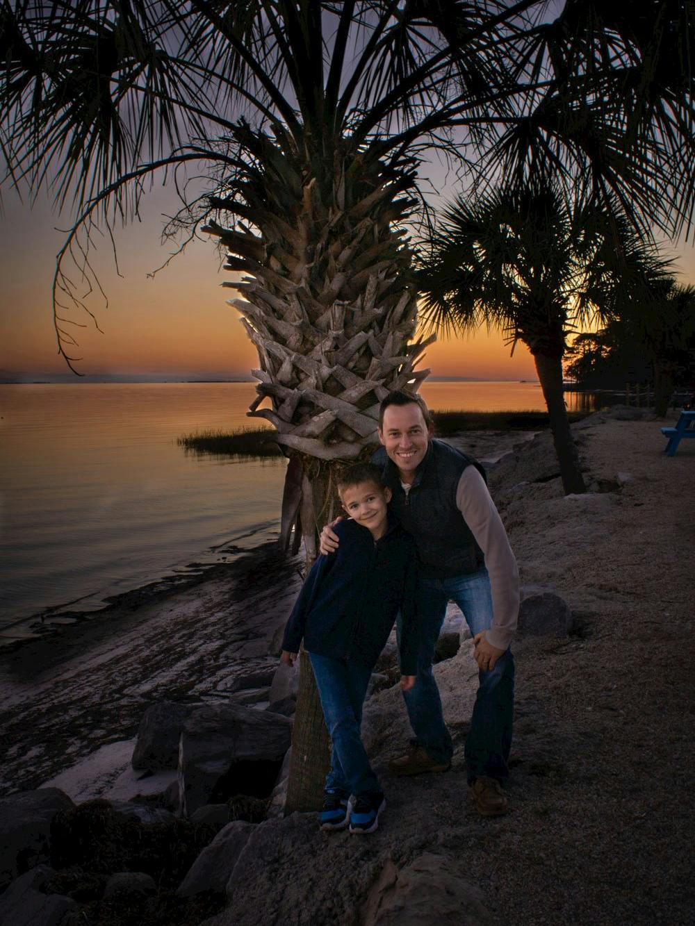 Blog photo Hangin' with the Hagens in Ho-Hum RV Park Lou and Travis Hagen posing in front of Palm Tree at park