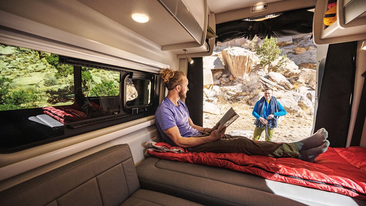 Sanctuary Sprinter Van RV in Utah with man sitting inside on comfortable interior